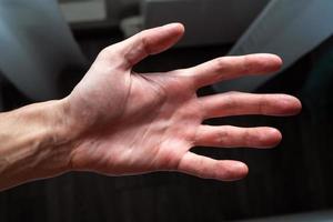 Close-up Of Human Hand Against Gray Background photo