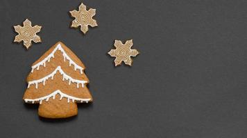 Banner with a gingerbread Christmas tree and three snowflakes. photo