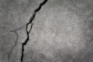 Concrete background with rough deep crack. Gray back. grunge photo