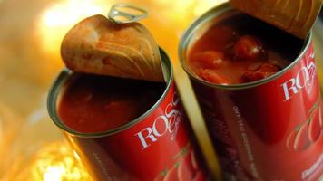 Pour the lightly canned tomatoes over the chorizo ingredients that are frying. Macro shooting video