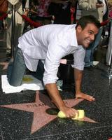 Cameron Mathison cleaning the Susan Lucci Star on the Hollywood Walk of Fame adjacent to the Kodak Theater piror to Daytime Emmys at the Hollywood and Highland complex in Hollywood, CA June 19, 2008 photo