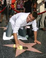 Cameron Mathison cleaning the Susan Lucci Star on the Hollywood Walk of Fame adjacent to the Kodak Theater piror to Daytime Emmys at the Hollywood and Highland complex in Hollywood, CA June 19, 2008 photo