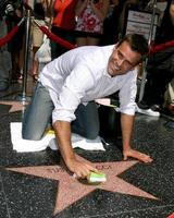 Cameron Mathison cleaning the Susan Lucci Star on the Hollywood Walk of Fame adjacent to the Kodak Theater piror to Daytime Emmys at the Hollywood and Highland complex in Hollywood, CA June 19, 2008 photo