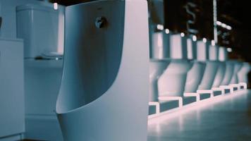 Rotating washbasin. Studio filming. In the background a row of toilets. 4k video