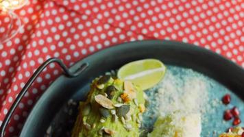 Mexican corn elote in three ways. Pressed with cheese, guacamole and pomegranate. Maxican flag video