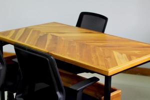 Office desk made of wood with a black work chair photo