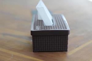 Brown tissue box on a wooden table photo