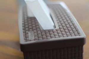 Brown tissue box on a wooden table photo