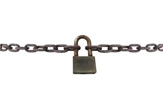 An old rusty padlock closed on a massive chain on white background photo