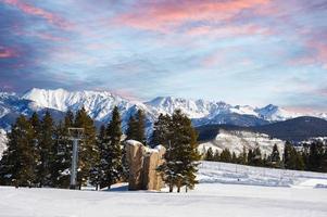 A beautiful morning on the ski slopes in Colorado with perfect skiing conditions . photo