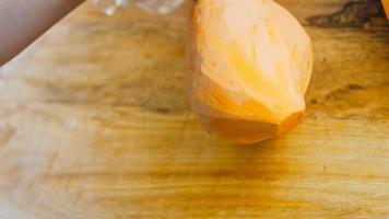 The chef cuts the sweet potatoes into slices. Romantic atmosphere in the background video