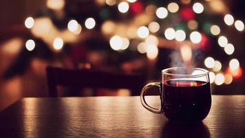 Steaming hot mulled wine with Christmas background loop video