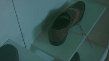 The shoe factory. There are pieces of shoes in the background. The sole and the mannequin video