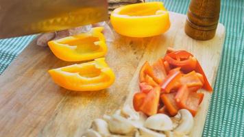 Shot on the slider of chopped and fresh vegetables. Peppers of various colors and mushrooms with red onions video