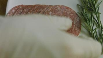 Flat charcuterie with salami, different kinds of cheese. It has dried fruits, various nuts and honey. Holiday arrangement with burning candles video