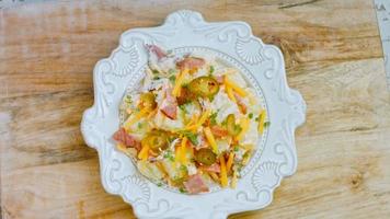 Jalapeno pepper, potato salad with bacon. Food in the retro style of the 20s video