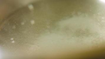 Boil the potatoes in an iron bowl. Macro shooting on intense steam video