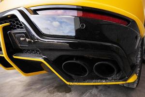 Dual exhaust of yellow sport car suv. photo