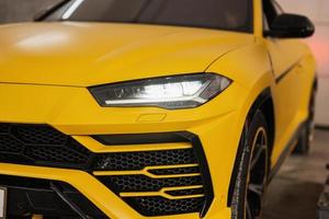 Headlights of yellow sport car suv. photo