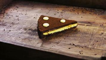 Chocolate tart with passion fruit on a wooden tray with decorations video