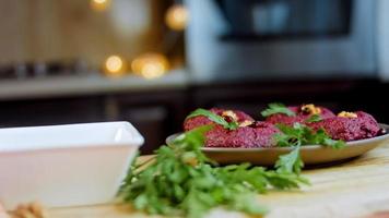 The girl tastes pkhali. Pkhali traditional Georgian food. Beetroot is used for the purple color. Walnut is used for decoration video