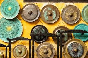 Gong - traditional Asian musical instruments on a street market. Hoi An, Vietnam. photo