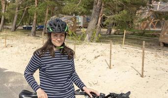 Young pretty woman in a bicycle helmet with a bicycle photo