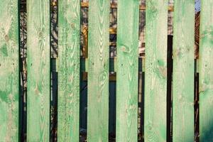 green board background, old painted board fence, grunge wood paneling, green background photo