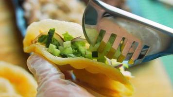 The chef prepares tacos. Add chopped fresh salad video