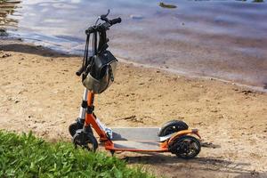 electric scooters parked on the shore of the lake, electric scooter riding, walking together on scooters photo