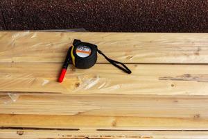 construction tape measure, marker and boards on the construction site, construction, repair photo