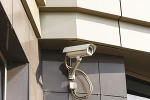 Security camera on dark modern building, security technology, building security, surveillance and security photo