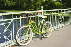 beautiful bike cruiser parked on the bridge over the river, cycling, outdoor activities photo