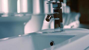 Rotating washbasin. Studio filming. In the background a row of toilets. 4k video