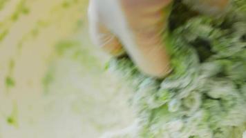 The chef spreads the green dough with a rolling pin. Tortillas prepared and decorated with spinach and beets. Red and green tortillas video