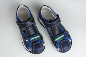 Children's sandals isolated on a white background. Children's shoes. Dark blue color photo