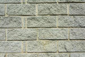 el fondo de ladrillo gris, la textura de una antigua pared de bloques grises en bruto foto