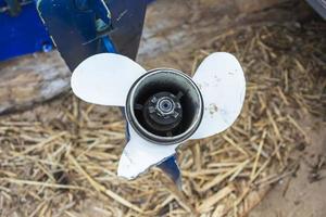 Damaged outboard motor propeller, aluminum propeller with a broken blade close-up, a problem on fishing photo