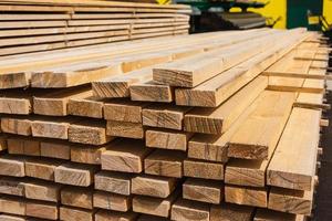 a stack of wooden boards, wooden boards at a sawmill, a warehouse of boards on the site of a building materials store. Wood, timber, wood blanks, construction material