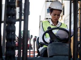 Engineer foreman staff employee white hardhat helmet sit forklift driver female woman lady black skin african person people import export shipping logistic cargo report work job factory transpotate photo