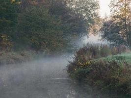 Autumn time at a river in germany photo