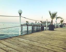 pontoon at sea. sea voyage in a warm country. a large and wide pontoon for tourists with lanterns for artificial light at night. walk on the water photo