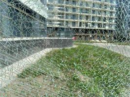 Beautiful broken anti-vandal transparent shiny cracked glass. The background. Texture photo