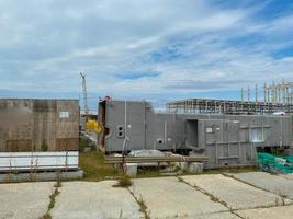 A large outdoor warehouse at a construction site, a warehouse for industrial equipment and materials in boxes at an open-air storage site photo