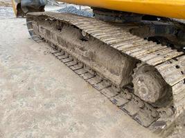 Excavator caterpillar in the mud at a construction site. Excavator wheels in the mud photo