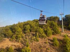 Modern beautiful cable car, lift, funicular in the mountains on vacation in a warm tropical eastern paradise country southern resort photo