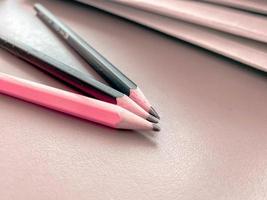 Three pencils lie sharply sharpened next to folders with sheets of paper and documents on the working business desk in the office. Stationery photo