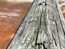 Surface texture of natural gray wood in the form of a board and rusty old oxidized corrosive metal iron close-up view. The background photo