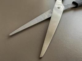 Black metal sharp scissors for paper on the working office table. Business work photo