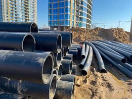 Large industrial black plastic polypropylene modern large diameter plumbing plumbing pipes at construction site in water pipe laying and construction and renovation of buildings and houses photo